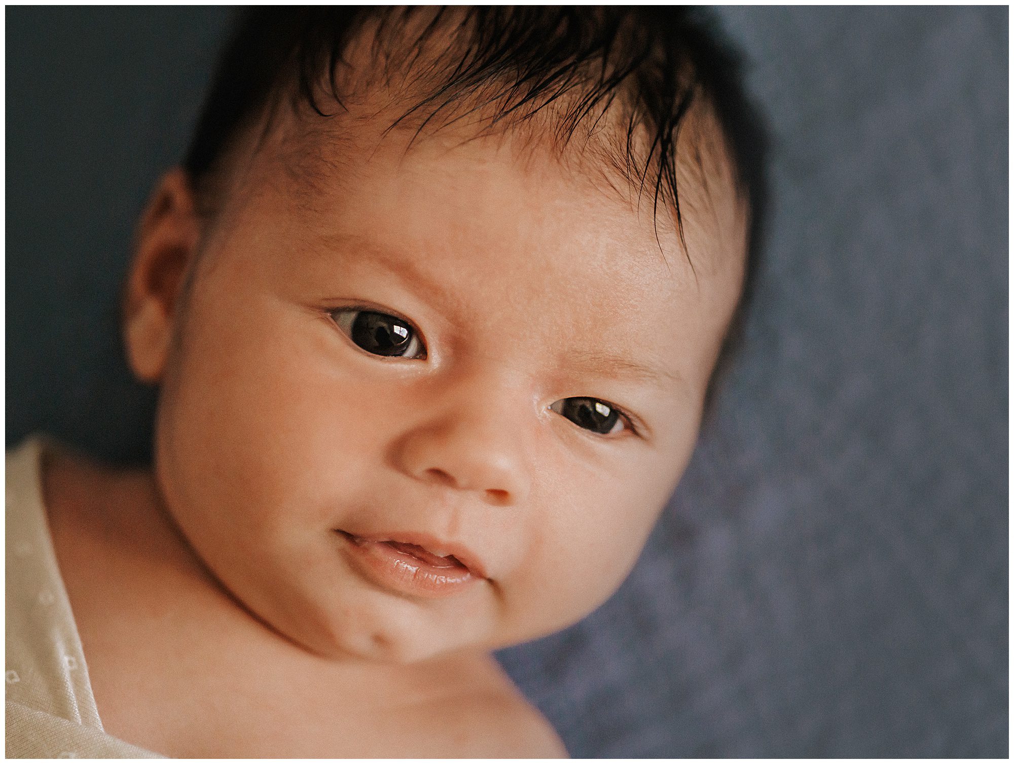 Close up portrait of newborn baby boy during lifestyle newborn session