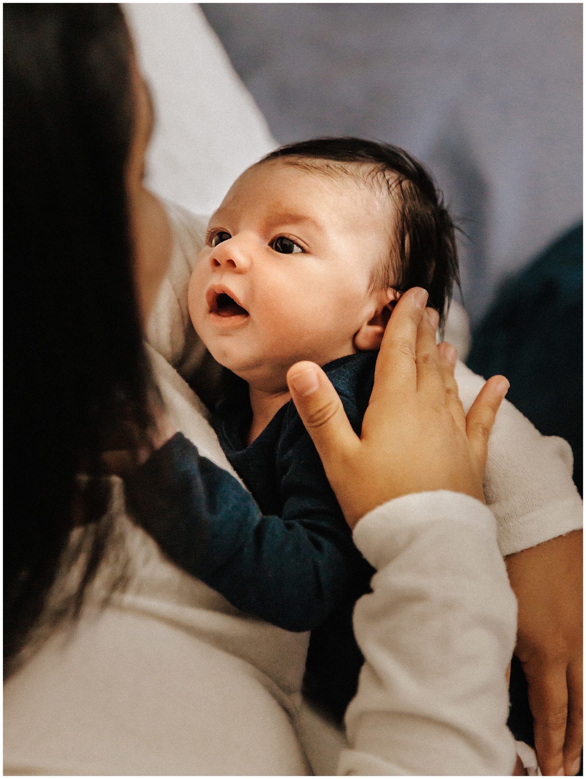 Baby boy gazing up at mama during lifestyle newborn session near nashville tn