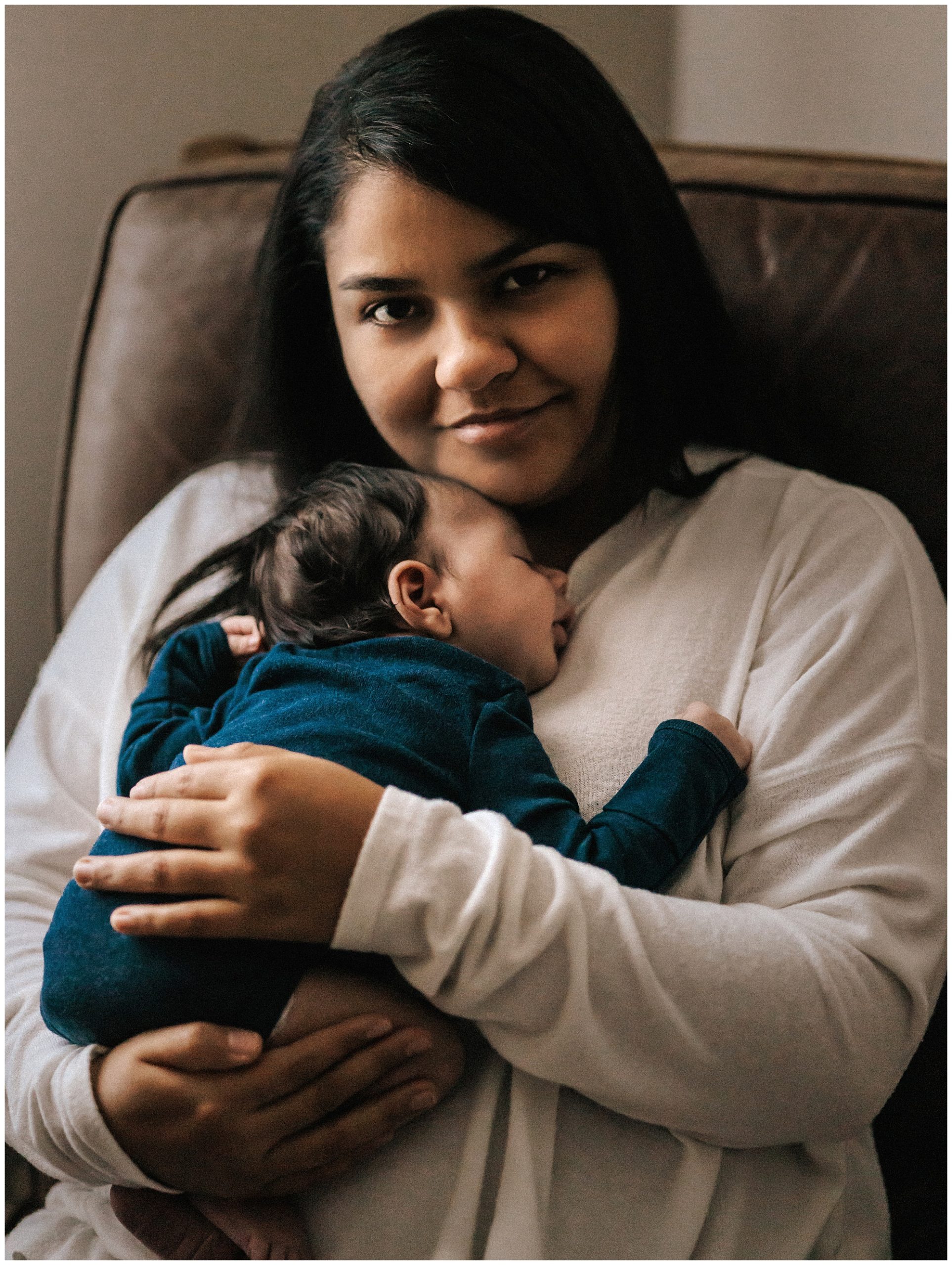 Mother holding sleeping newborn baby boy during lifestyle newborn session in Murfreesboro