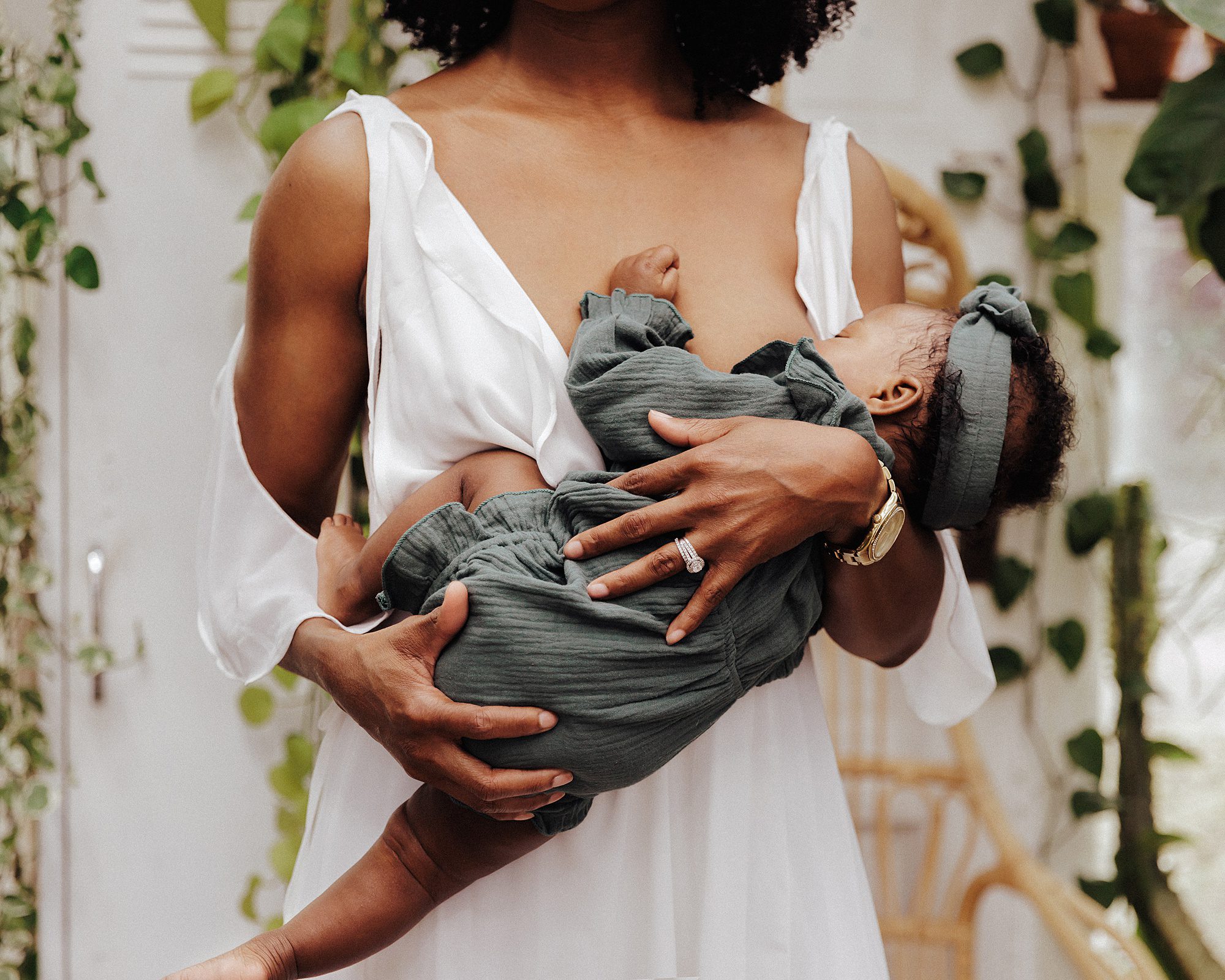 Breastfeeding Portrait of a mother nursing her baby in East Nash Greenhouse during a greenhouse mini session by family and motherhood photographer ashley erin west