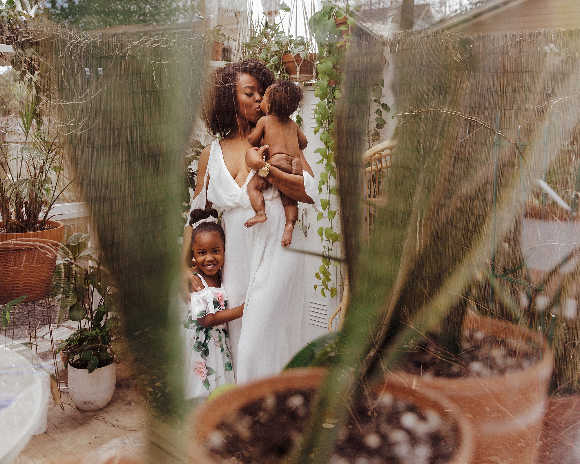 Spring Mini Sessions in Nashville Portrait of a mother and her baby in the East Nash Greenhouse during a greenhouse mini session by Family and Motherhood Photographer Ashley Erin West