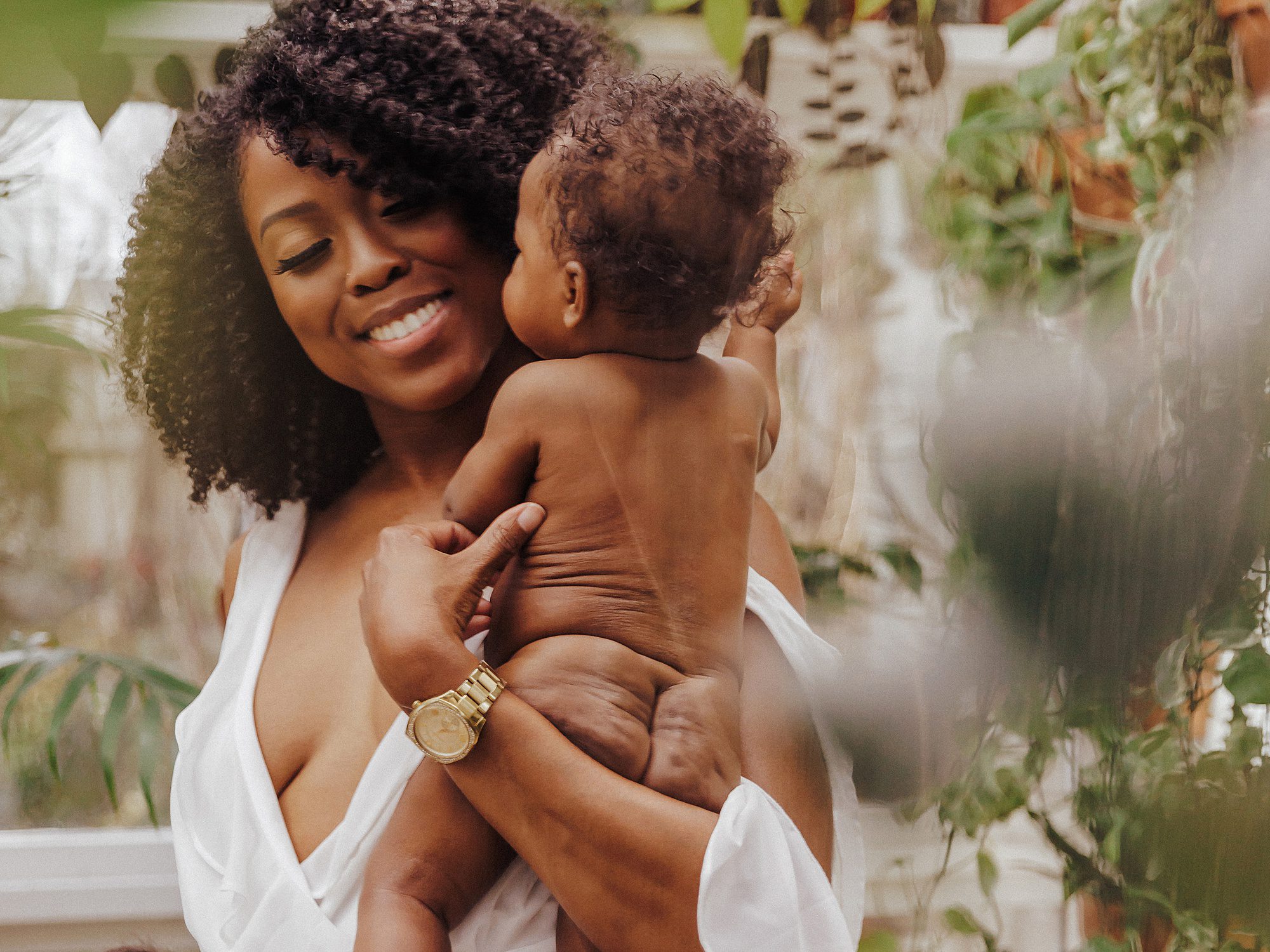 Portrait of a mother and her baby in the East Nash Greenhouse during a greenhouse mini session by Family and Motherhood Photographer Ashley Erin West