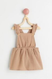 Product Photo of a tan cotton overall dress for baby girls
