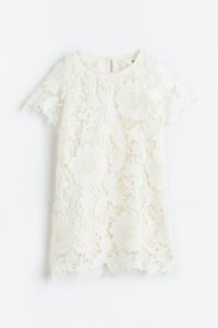 Product Photo of a toddler dress that is white lace