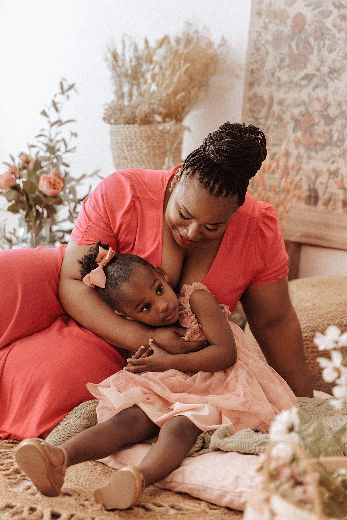 Mother cradles her daughter in her lap during a spring mini session 